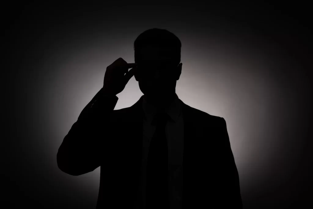 Black silhouette of businessman in glasses